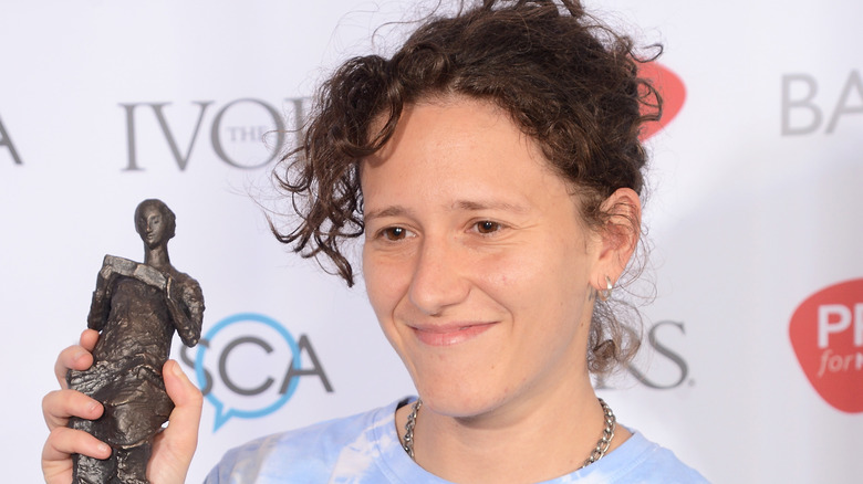 Mica Levi holding award