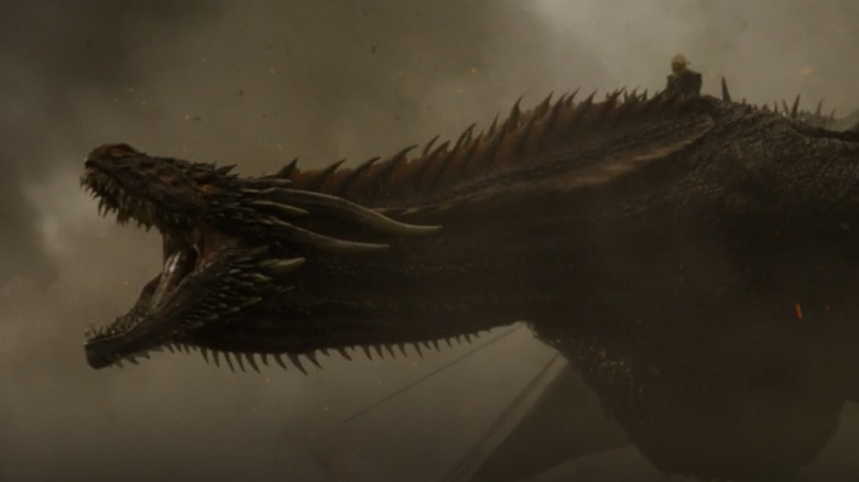 Daenerys riding Drogon amid smoke