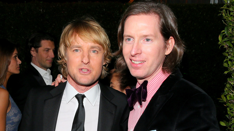 Wes Anderson and Owen Wilson in the middle of smiling