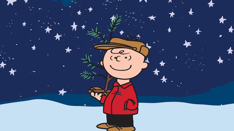 Charlie Brown holding small tree