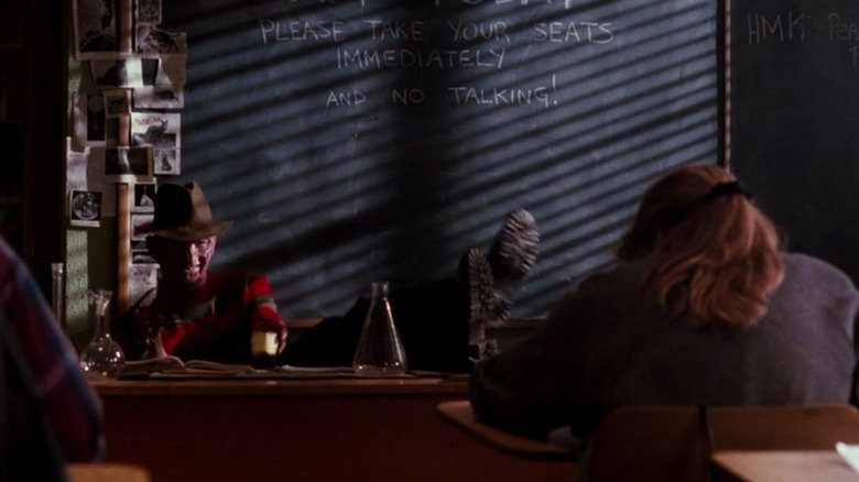 Freddy sits at school desk