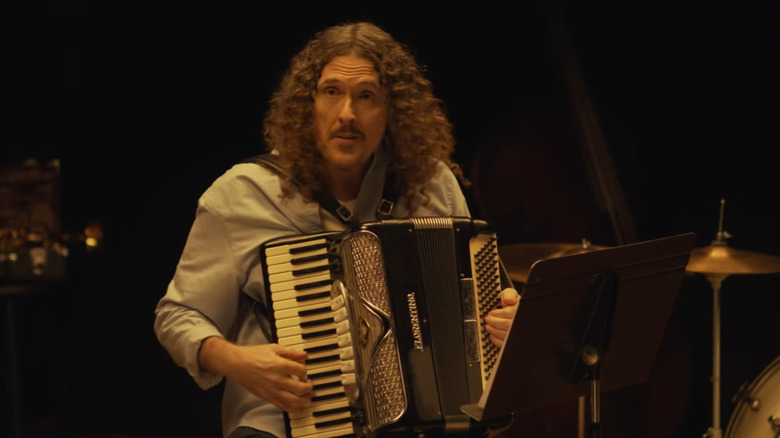 Weird Al holding accordion