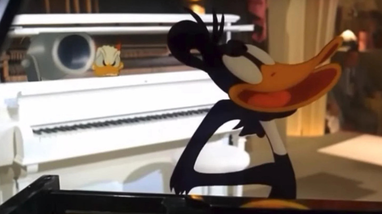 Donald Duck aiming cannon at Daffy Duck