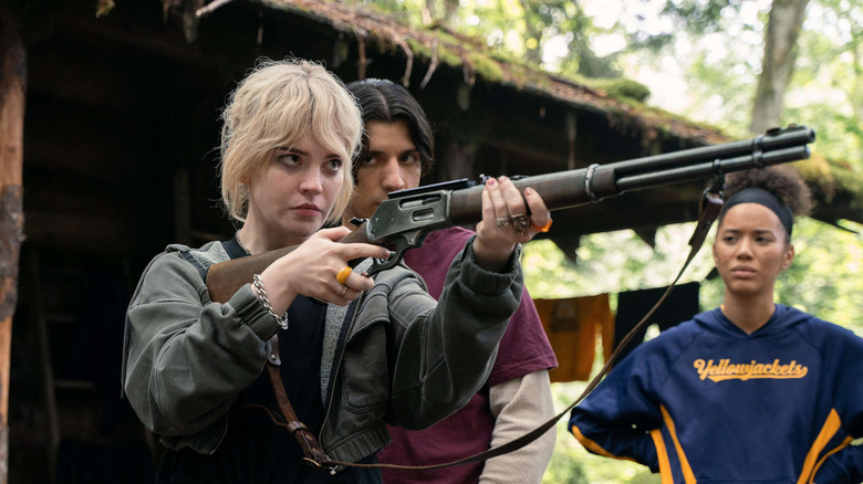 Young Natalie holding rifle Yellowjackets