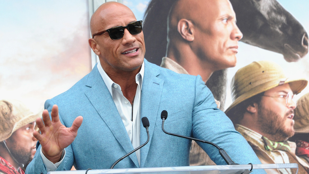 Dwayne Johnson standing at podium