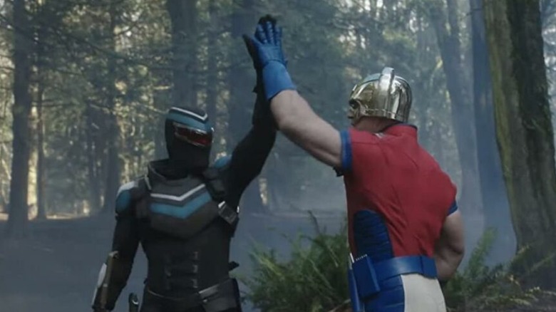 Peacemaker and Vigilante high-five each other