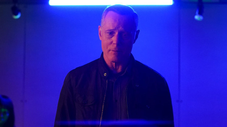 Hank Voight standing in blue light