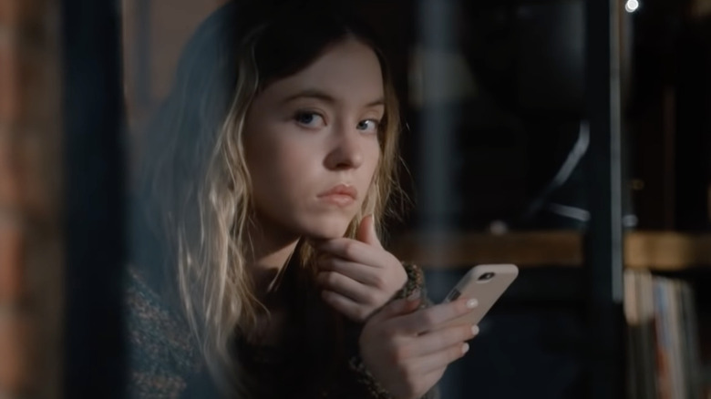 Sydney Sweeney holding phone in The Voyeurs