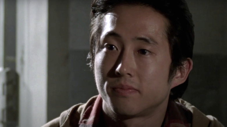 Glenn Rhee wearing a hoodie