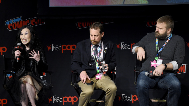 Angela Kang, Scott Gimple, and Robert Kirkman sit on stage