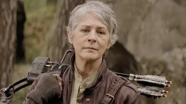 Carol carrying Daryl's crossbow