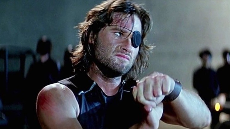 Snake Plissken handcuffed