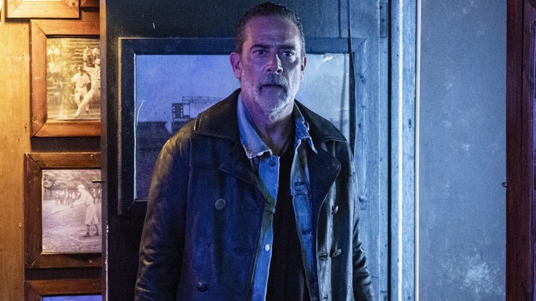 Negan surrounded by photos