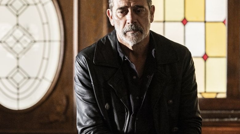 Negan sitting in a church