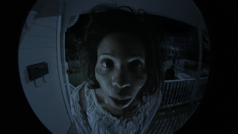 Morgan Jones' zombified wife turns the doorknob in the walking dead episode 1