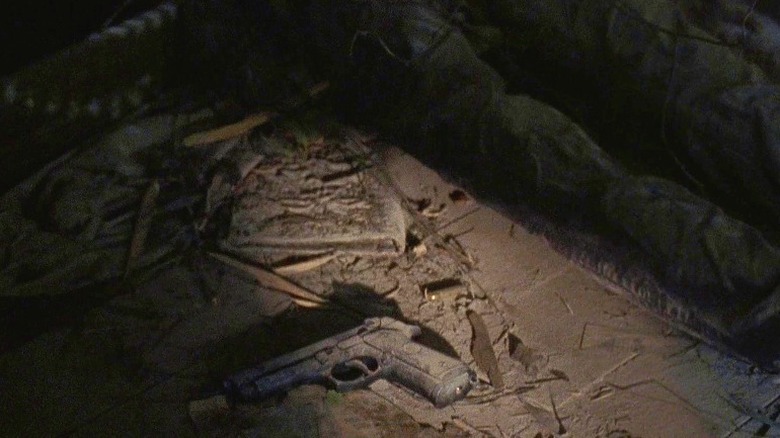 The Necronomicon lying on the floor next to a body in The Walking Dead