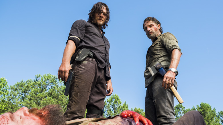 Daryl and Rick standing over a body