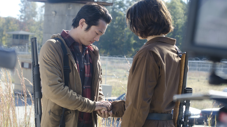 Glenn holding Maggie's hand