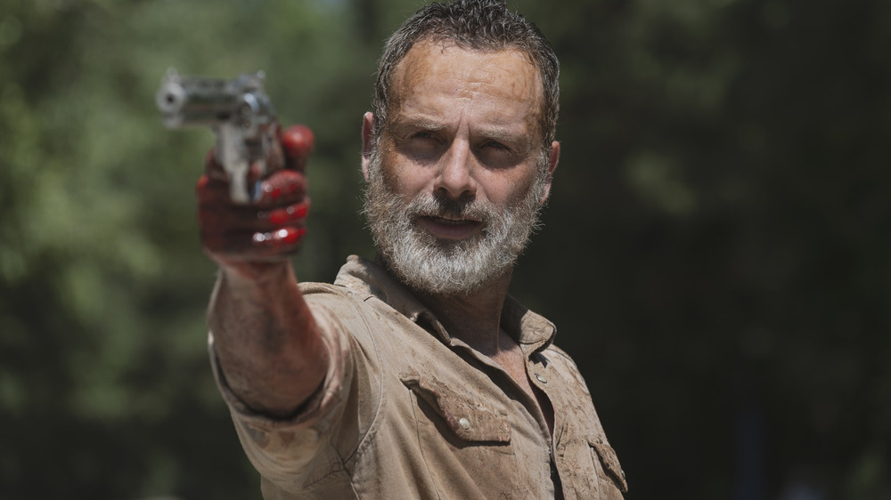 Bearded Rick Grimes pointing a gun