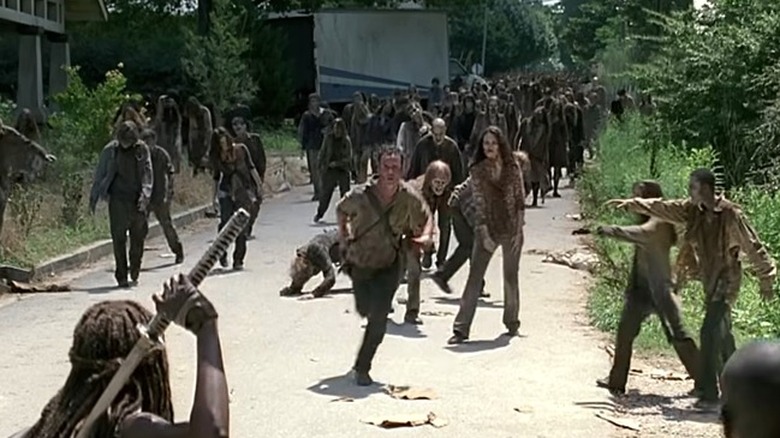 Rick running from horde of walkers