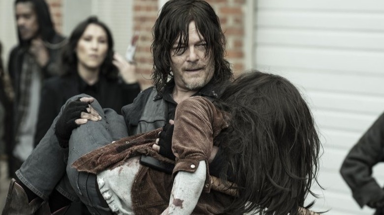 Daryl carries a shot Judith