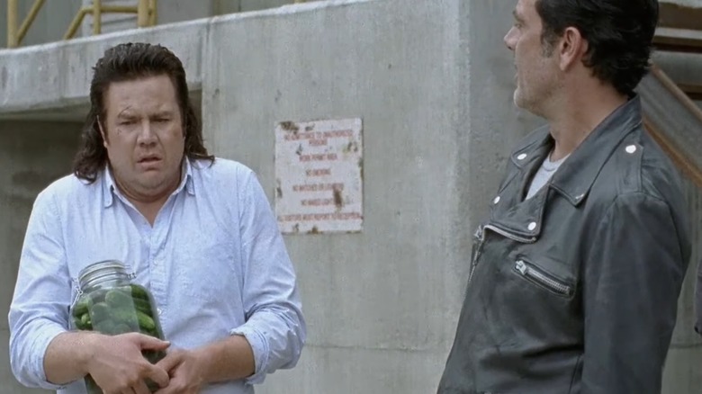 Eugene holding pickle jar with Negan