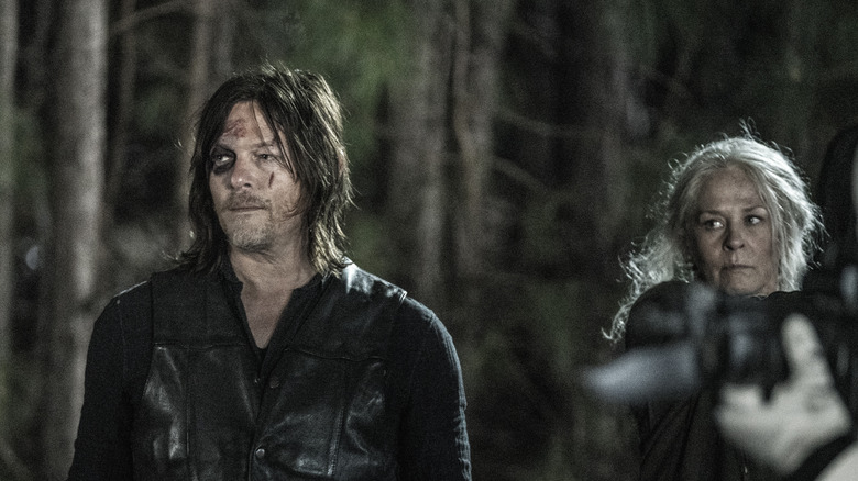 Daryl and Carol standing together