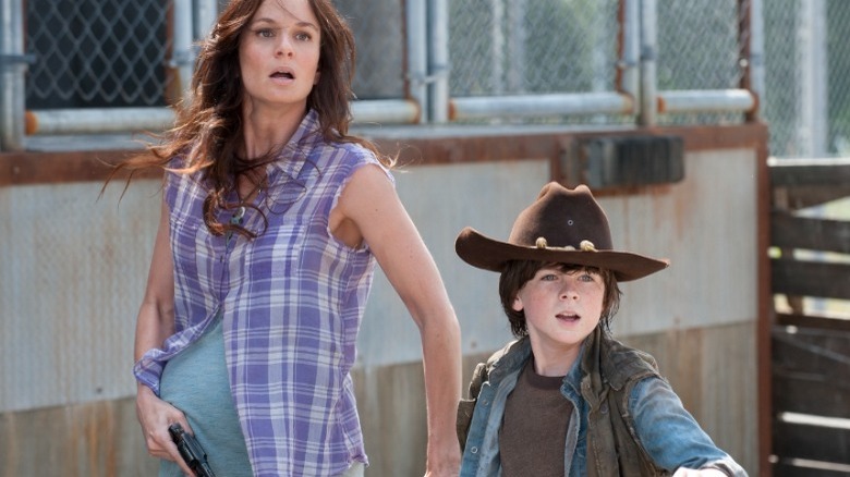 Lori holding Carl's hand