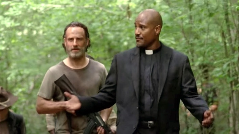 Rick Grimes and Father Gabriel walking in the woods