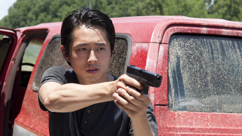 Glenn pointing a gun