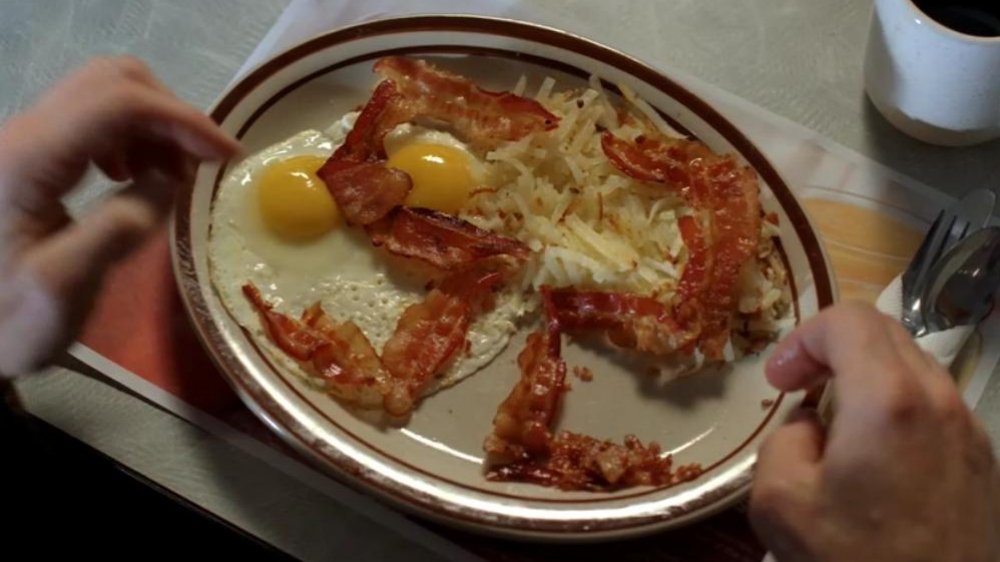 A plate of eggs and hash browns topped with bacon arranged into a '52' on Breaking Bad