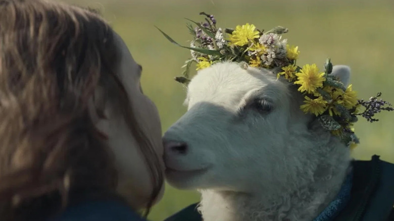 Noomi Rapace kissing lamb