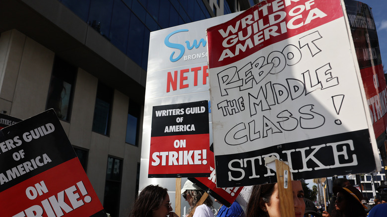 Writers holding signs on strike