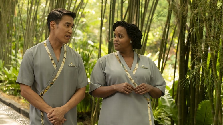 Belinda and Pornchai walking on a tree-lined path