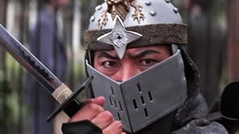 Sho Kosugi, in ninja gear, wields a sword