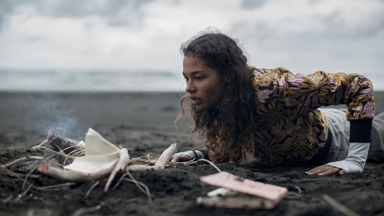 Nora looking at fire on the beach