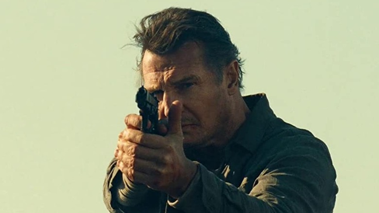 Liam Neeson aiming a gun