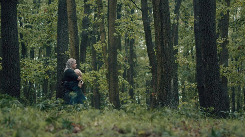 Geralt hugging Ciri in forest