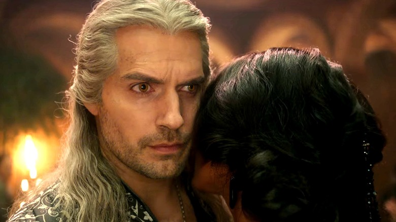 Geralt stares forward, Yennefer whispers in ear