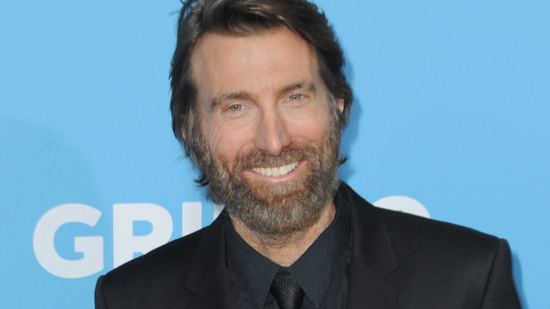 Sharlto Copley in Suit Smiling