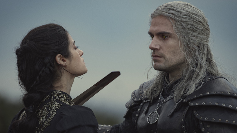 Geralt holding sword to Yennefer