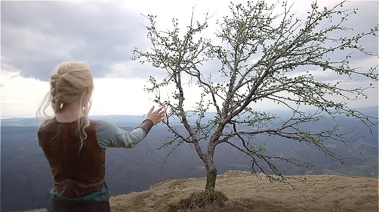 Ciri reaching out toward a tree