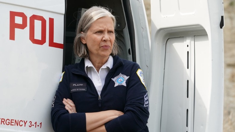 Amy Morton leaning on police van