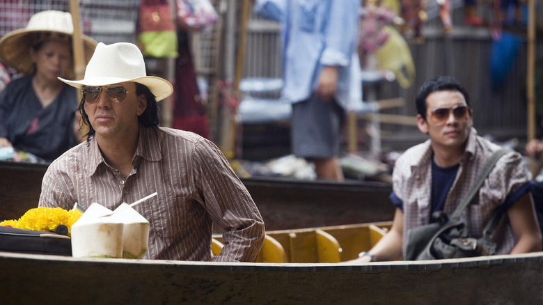 Nicolas Cage and another actor in a boat