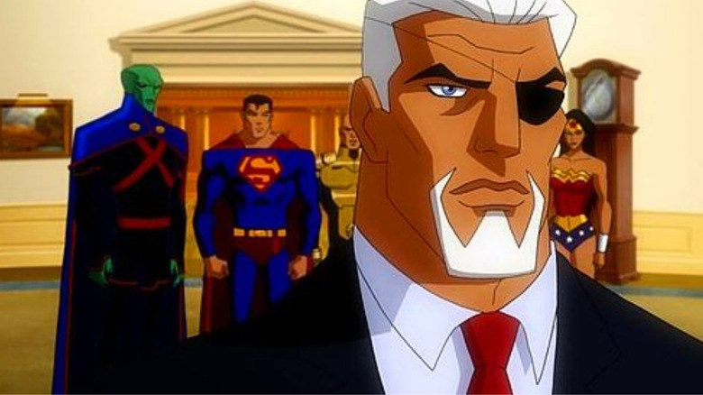 President Slade Wilson with his back to Superman, Wonder Woman, and Martian Manhunter in the oval office of Earth 3