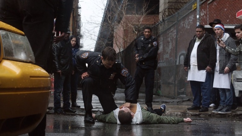 A police officer checks a shooting victim