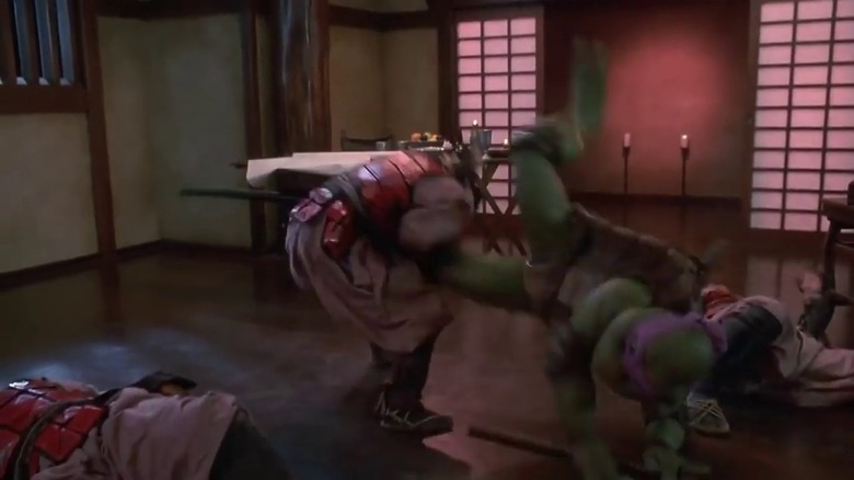 Donatello drop-kicking a samurai