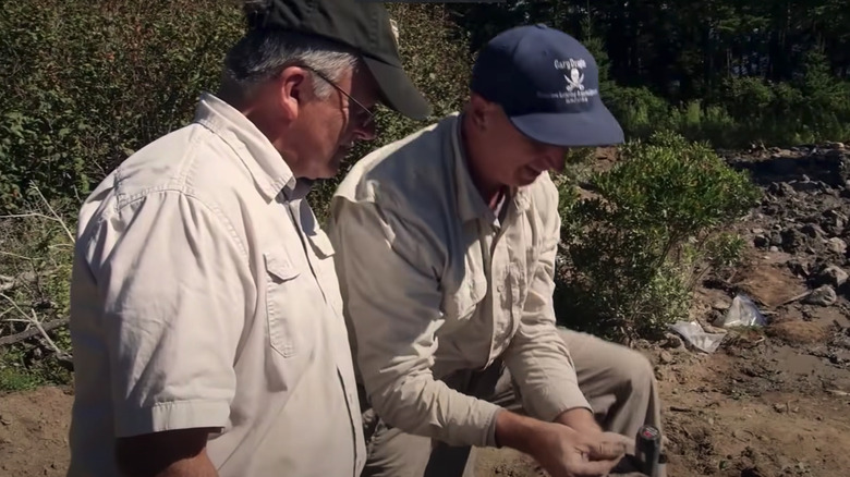 Charles Barkhouse Gary Drayton Curse of Oak Island examining found coin