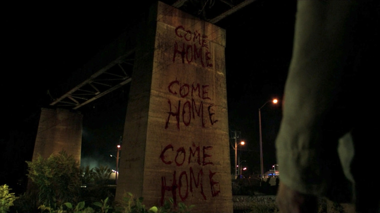 "Come Home" written three times in blood.