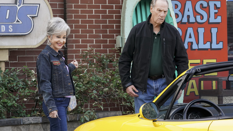 Meemaw and Dale looking at Meemaw's yellow car